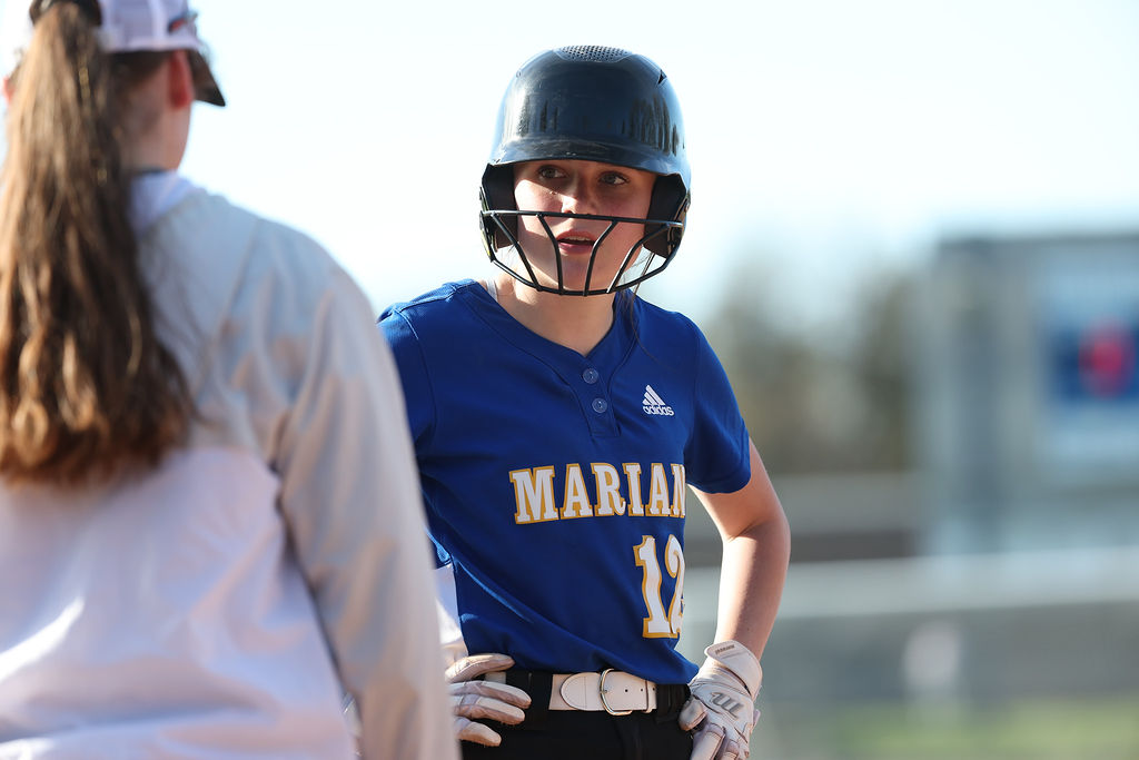 Catcher Ava Hierlihy receives instructions from head coach Abbey Maresh against Troy Athens (Leon Halip)